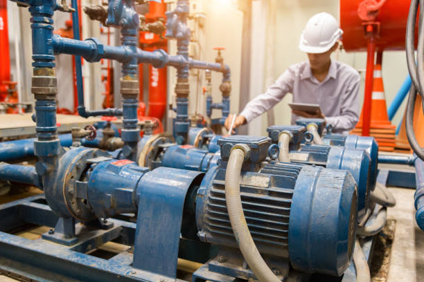 istock Asian engineer maintenance checking technical data of  system equipment Condenser Water pump and pressure gauge ,  water pump. 1097682644