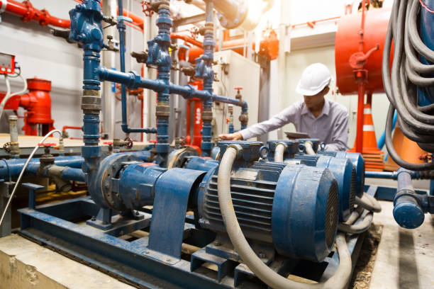 istock Asian engineer maintenance checking technical data of  system equipment Condenser Water pump and pressure gauge ,  water pump. 1097682726