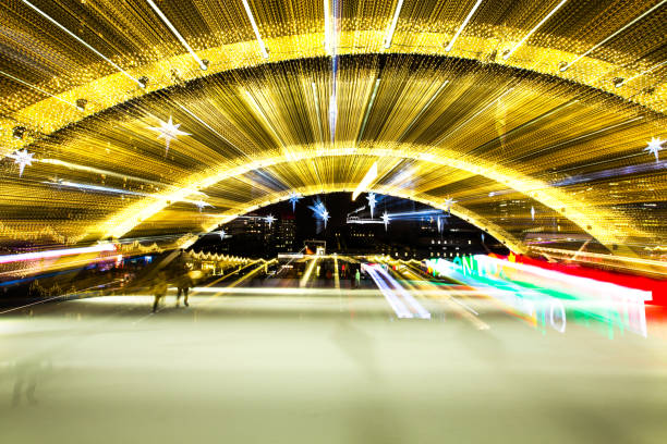 Toronto City Hall - Nathan Phillips Square Skating Rink Toronto, Ontario, Canada - December 14, 2018: Nathan Phillips Square is a public square at the entrance to Toronto City Hall. During the winter, a reflecting pond transforms into a free public skating rink. This photo depicts the skating rink during the Christmas season. The photo is a long exposure zoom. city zoom out stock pictures, royalty-free photos & images