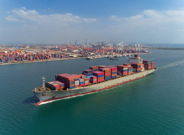 istock Container ship driving from sea port logistics business import export, shipping or transportation concept background. 1097687360