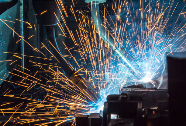 istock Welding robots movement in a car factory, Black and White 1097688590