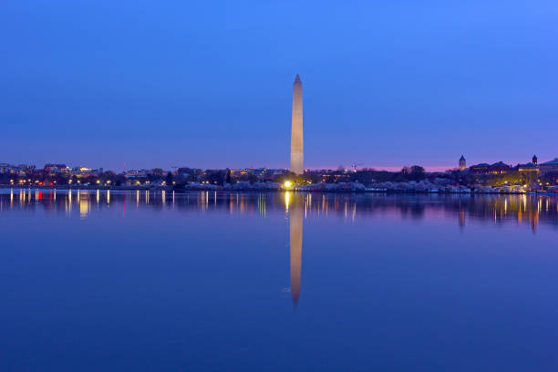 istock US capital panorama along Tidal Basin reservoir during cherry blossom at dawn. 1097688930