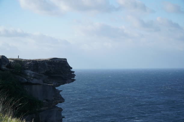 istock Cliff at seaside with big wave ocean on cloudy day 1097689084
