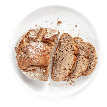 Sliced bread on a plate  isolated on  white background. Fresh Bread cutted in a  slices close up. Bakery, food concept. Top view