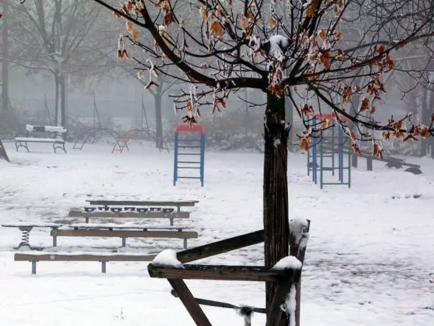 Photo of snow covered playground with steel climber equipment