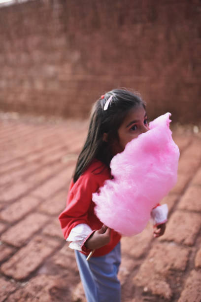 istock Young girl (4-5 years) eating cotton candy 1097716650