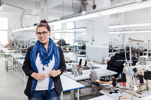 Businesswoman posing in textile factory.