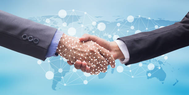 istock close up business man handshake with business robot artificial intelligence (AI) on motion blur background with world map and virtual interface hologram connect for future technology concept 1097729134