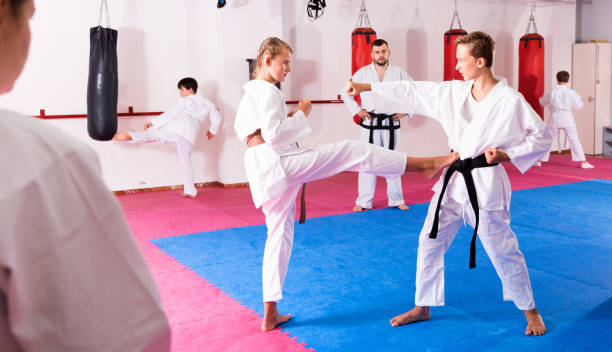 istock Kids in kimonos exercising techniques in pair during taekwondo class at gym 1097730822