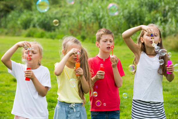 istock children blowing bubbles in park 1097731224