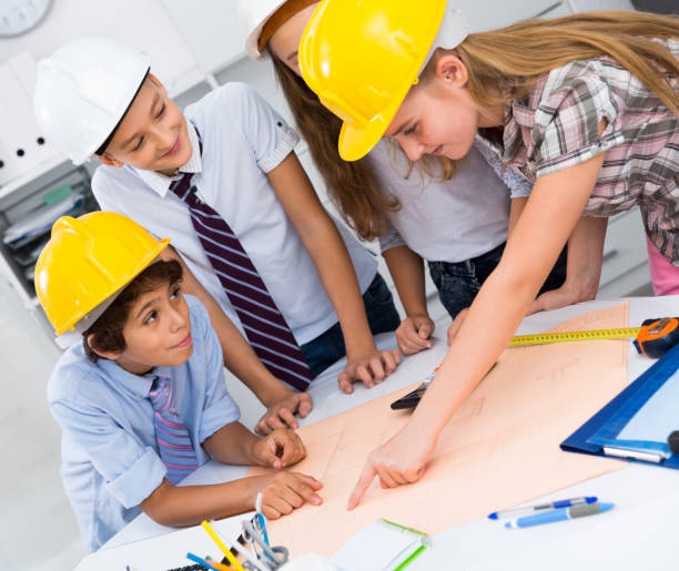 istock Children in helmet talking about building 1097732632