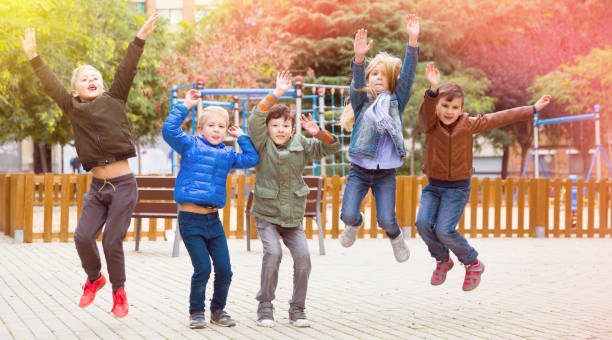 istock Happy children jumping together 1097735444