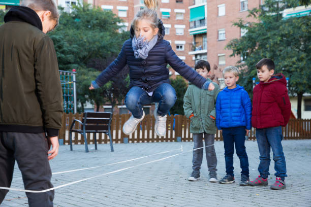 istock Kids skipping on chinese jump rope 1097735510