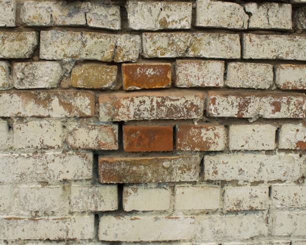 istock The white brick  wall is real with rose shades from rain to red brick. 1097737982
