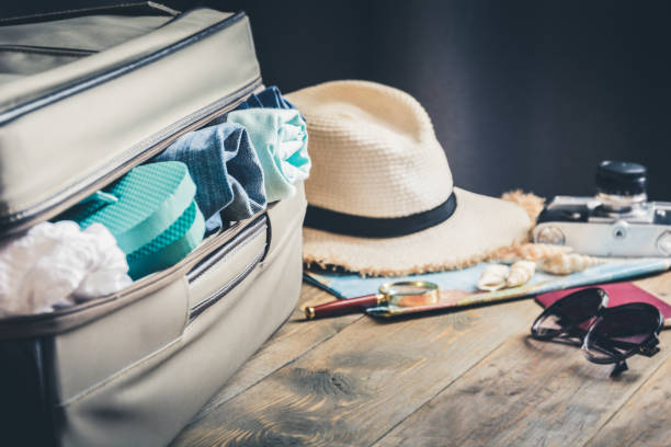 istock Open suitcase with female outfit for travel. Packing things. 1097739778
