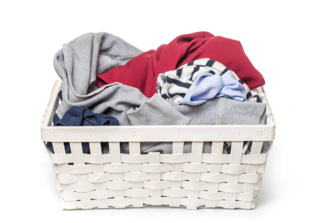 istock Clothes in a laundry wooden basket isolated on white background 1097742348