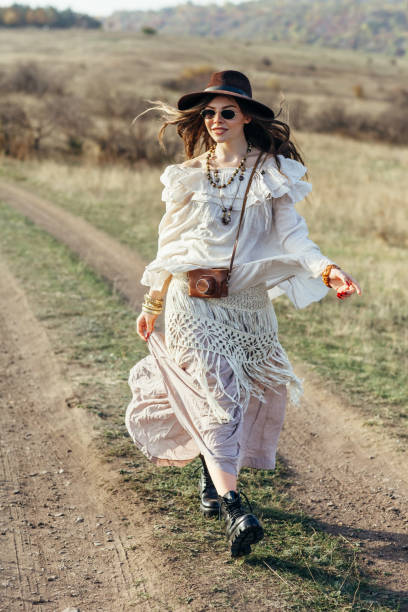 istock Beautiful young boho woman walking on nature 1097744412