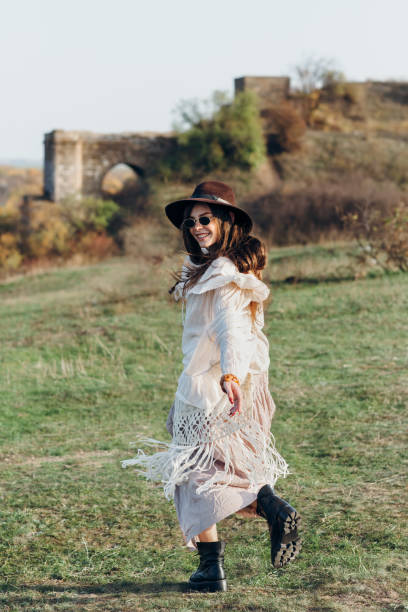 istock Beautiful young boho woman walking on nature 1097744420