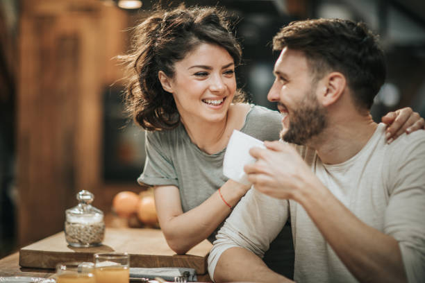 istock Embraced couple in love communicating during coffee time in the kitchen. 1097745096