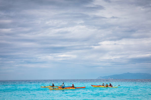 Kefalonia, Greece - September 30, 2018: Group of tourists kayaking on Kefalonia island in Greece. View from the Fteri beach.