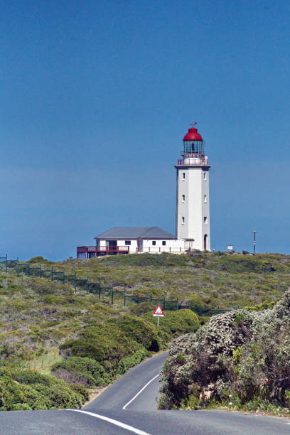 istock Lighthouse at the end of a road 1097747528