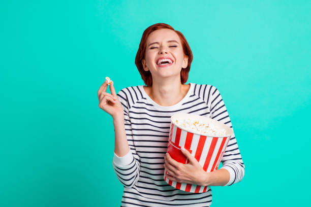 istock Funky crazy cheerful ecstatic overjoyed rejoicing lovely charming loud noisy pretty she her student holding large big full of sugary caramel sweet pop corn isolated turquoise background 1097749520