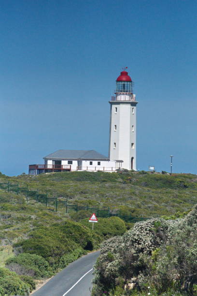 istock Lighthouse at the end of a road 1097749524