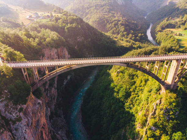 istock highway with high bridge cross canyon. blue clear water 1097749998