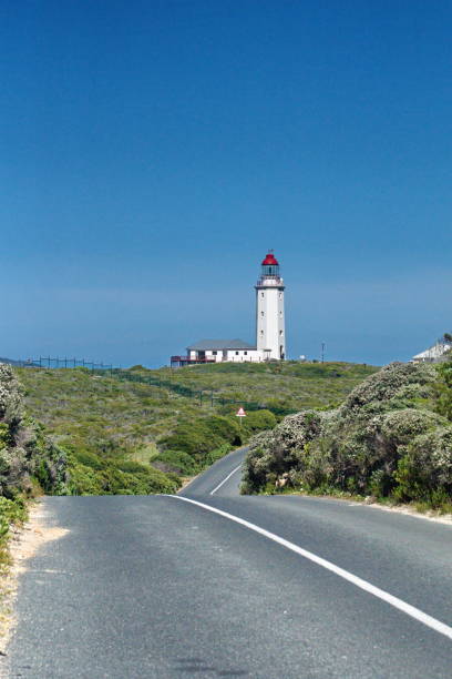 istock Lighthouse at the end of a road 1097753188