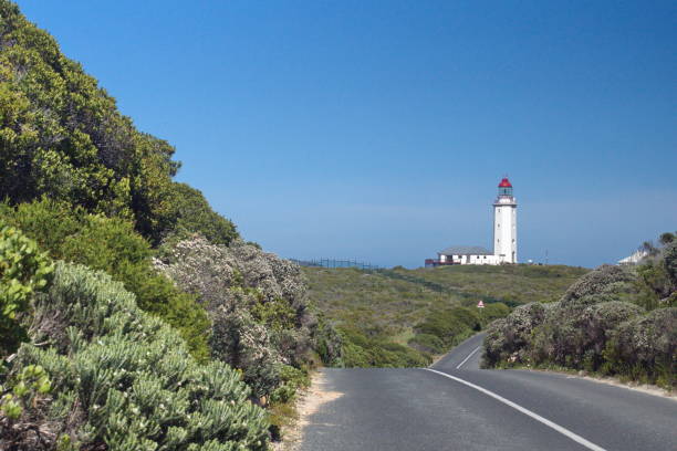 istock Lighthouse at the end of a road 1097755822