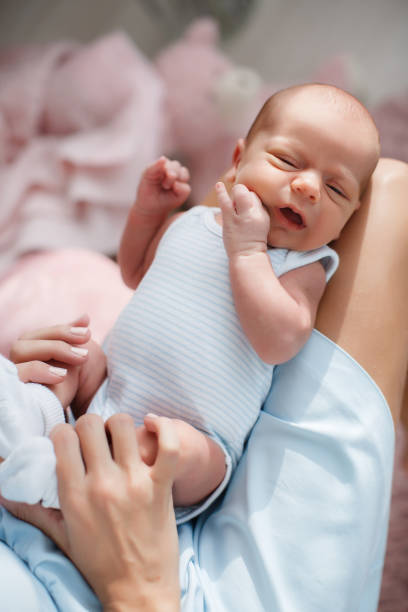 istock Newborn baby lying on his mother's lap 1097756508
