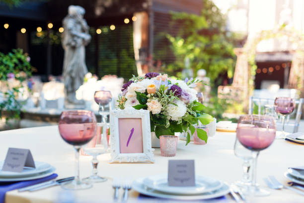 istock Flower table decorations for holidays and wedding dinner. Table set for holiday, event, party or wedding reception in outdoor restaurant. 1097756620