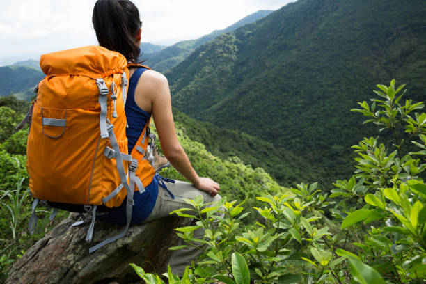istock Successful woman hiker enjoy the view at mountain peak 1097758024