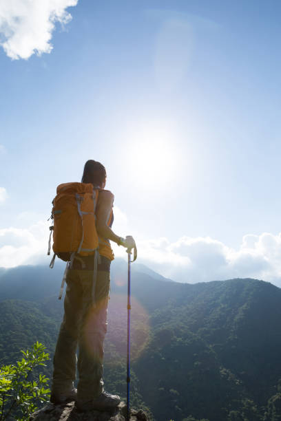 istock Successful woman hiker enjoy the view at mountain peak 1097758070
