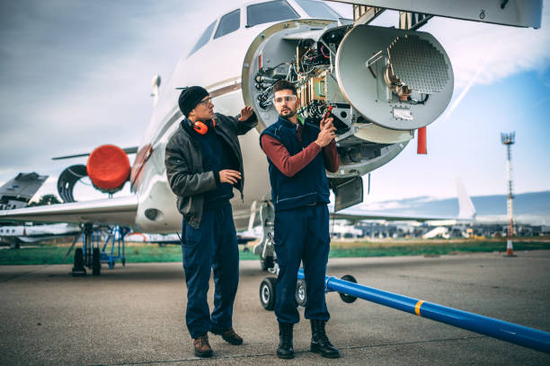 istock Two aircraft engineers working on a sensor array under the nose cone of a private jet parked on an airport tarmac 1097758132