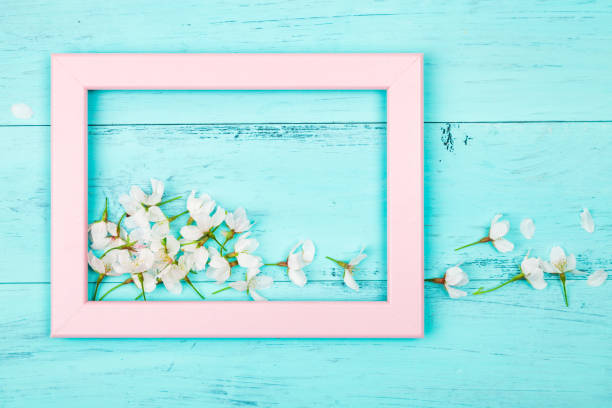 istock White spring flowers in a picture frame 1097758470