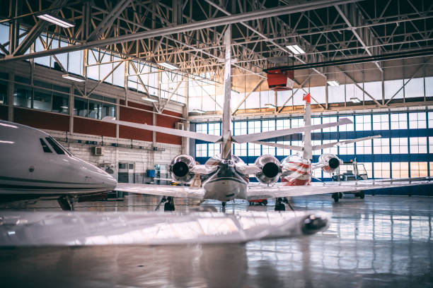 istock Multiple small, private airplanes parked in an airport hangar 1097758560