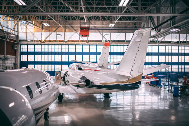 istock Three small private jets parked in an airport hangar 1097758562