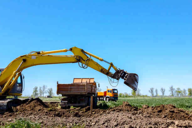 istock Excavator is loading a truck with ground on building site 1097759428