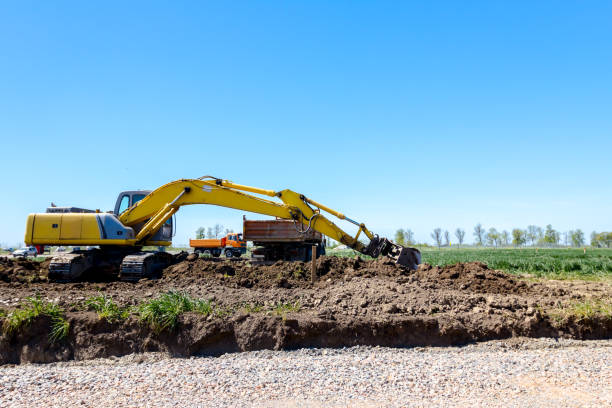 istock Excavator is loading a truck with ground on building site 1097759430