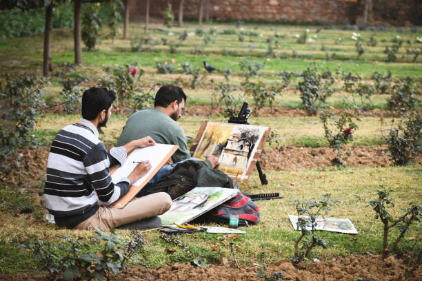 Couple of artist live painting at The Lodi Garden. Lodi Gardens or Lodhi Gardens is a city park situated in New Delhi, India. New Delhi, India - January 20 2018 : Couple of artist live painting at The Lodi Garden. Lodi Gardens or Lodhi Gardens is a city park situated in New Delhi, India. lodi gardens stock pictures, royalty-free photos & images