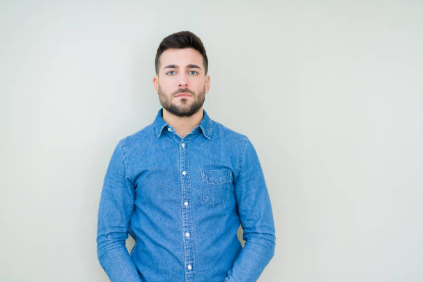 istock Young handsome man over isolated background with serious expression on face. Simple and natural looking at the camera. 1097761894