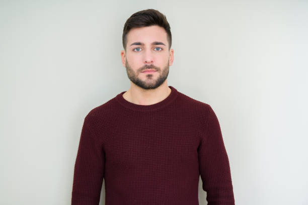 istock Young handsome man wearing a sweater over isolated background Relaxed with serious expression on face. Simple and natural looking at the camera. 1097762112
