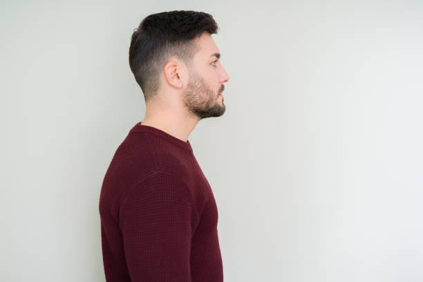 istock Young handsome man wearing a sweater over isolated background looking to side, relax profile pose with natural face with confident smile. 1097762142