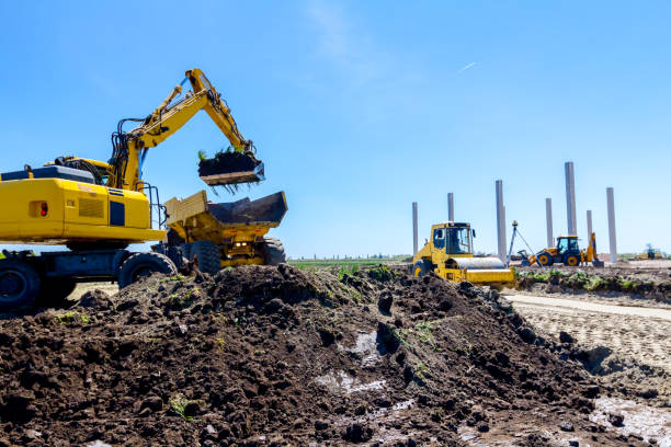 istock Excavator is loading a truck with ground on building site 1097762382