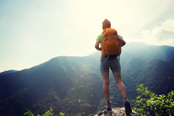 istock Successful woman backpacker enjoy the view at mountain peak 1097762764