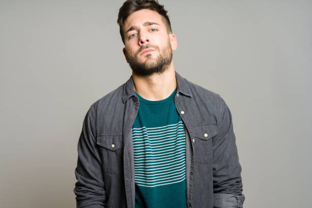 istock Young handsome man possing and modeling over grey isolated background 1097762822