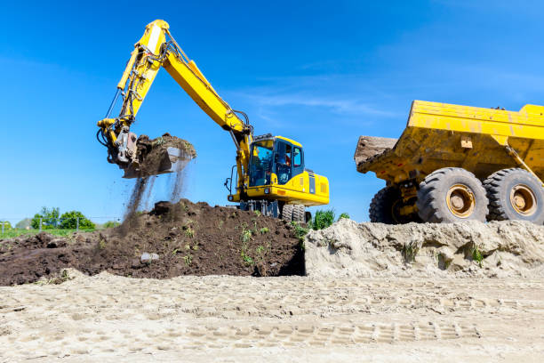 istock Excavator is loading a truck with ground on building site 1097764140
