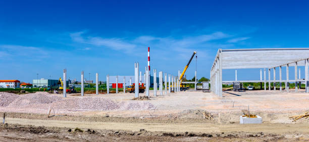 istock Panoramic view on landscape transform into urban area with machinery, people are working 1097764800