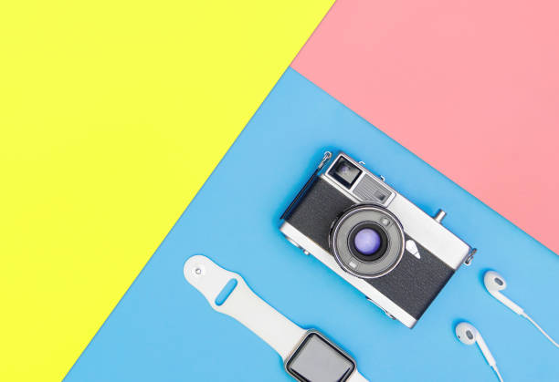 istock camera with smart watch earphone on blue and yellow pink 1097765390